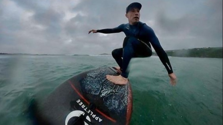 David Pascoe surfing and smiling