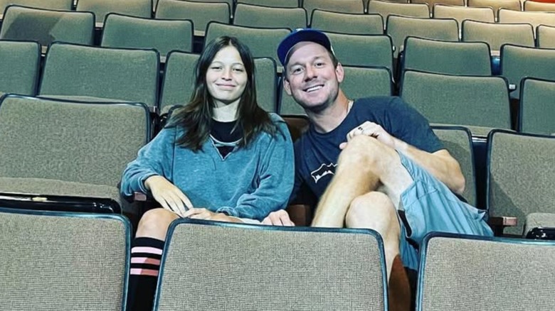 Jade and Brian Kleinschmidt smiling in theater chairs