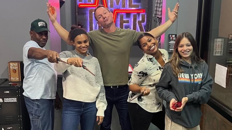 Jade, Mika, and Brian Kleinschmidt smiling with family members