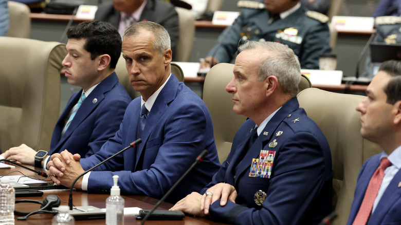 Corey Lewandowski sitting in the audience of a conference
