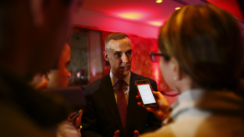 Corey Lewandowski surrounded by reporters