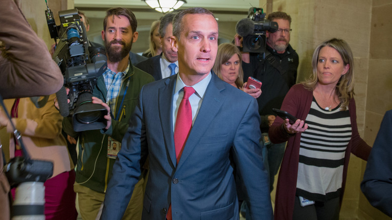 Corey Lewandowski surrounded by reporters