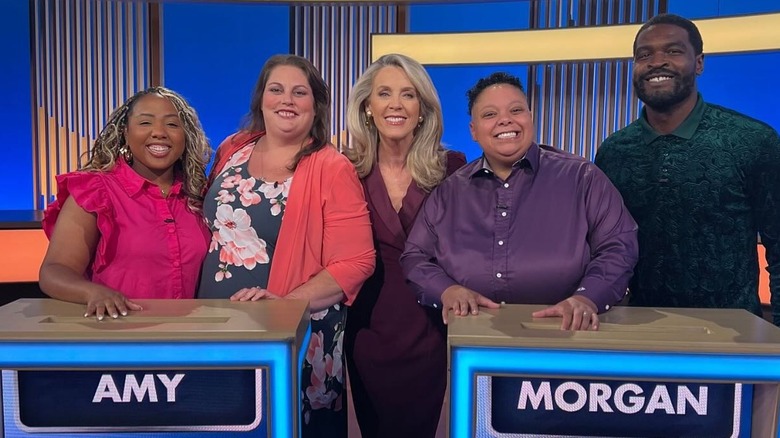 Deborah posing with contestants on The Perfect Line