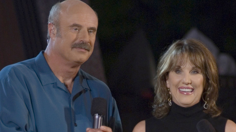 Dr. Phil and Robin McGraw holding microphones