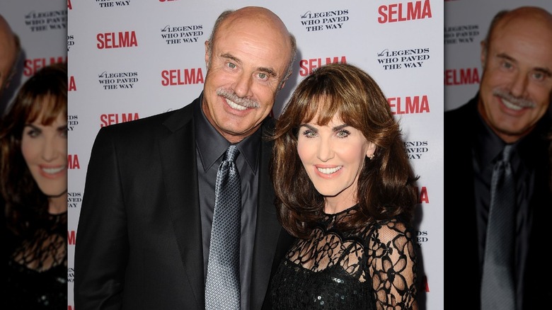 Robin McGraw and Dr. Phil McGraw posing at an event