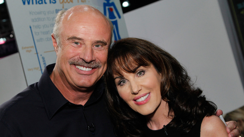 Robin McGraw and Dr. Phil McGraw posing at an event