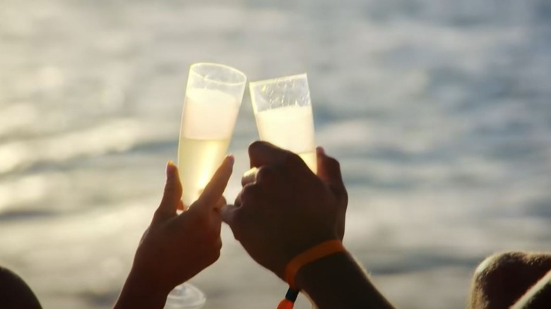 Two people clinking champagne glasses