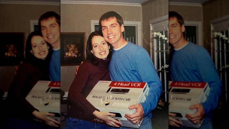 Clint Harp and Kelly Harp posing with a VCR in a throwback pic