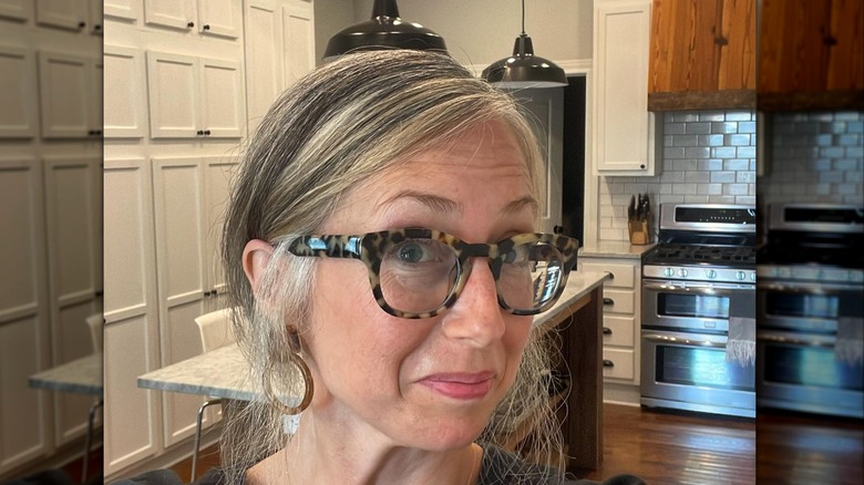 Kelly Harp smiles in the kitchen of her old house