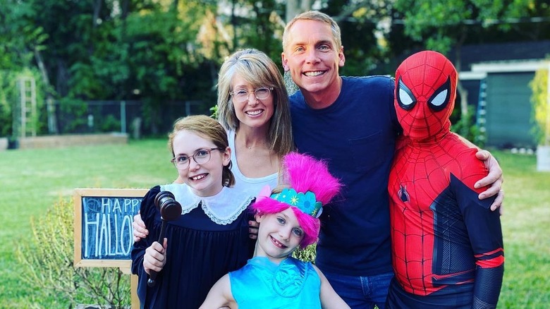 Clint and Kelly Harp smile with their three kids dressed up on Halloween outside