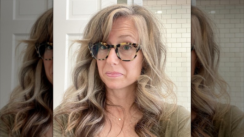 Kelly Harp wears her long hair down and glasses in a selfie