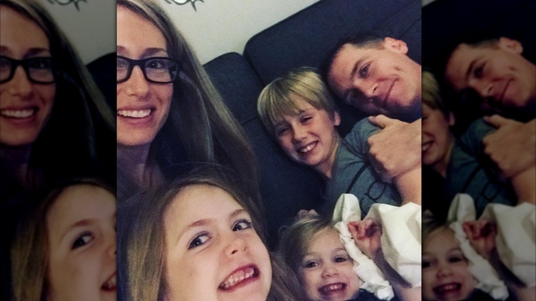 Clint and Kelly Harp posing with their three kids in a selfie