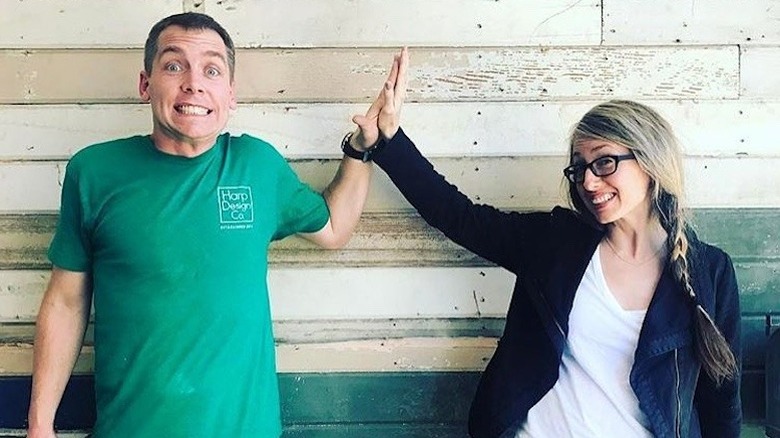 Clint and Kelly Harp high-five at Harp Design Company