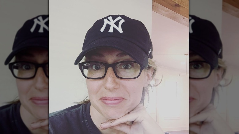 Kelly Harp wears a Yankees baseball hat in a selfie