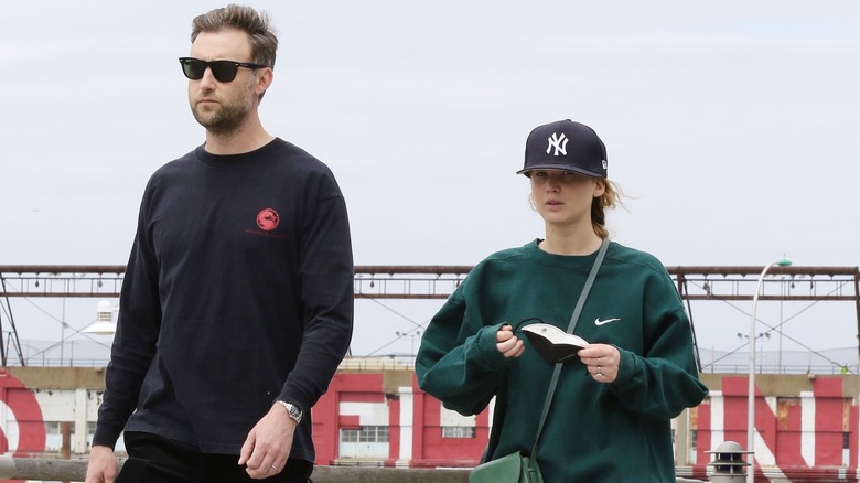 Cooke Maroney and Jennifer Lawrence walking by Hudson River