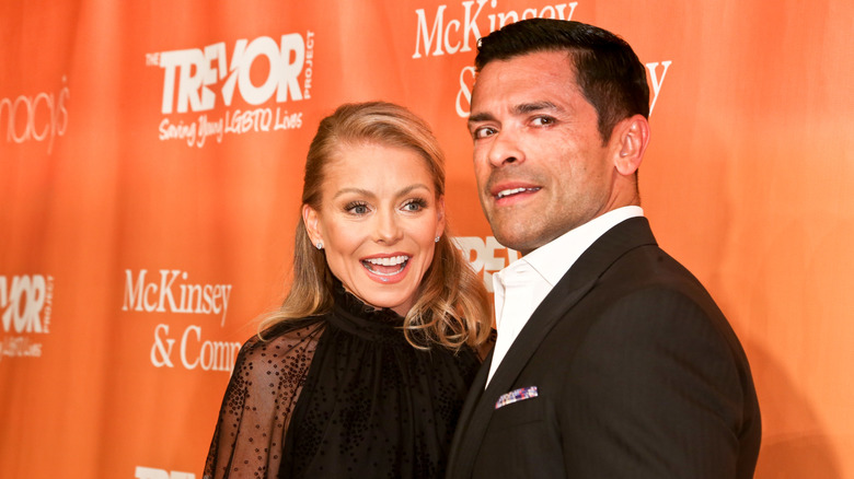 Kelly Ripa and Mark Consuelos posing at an event