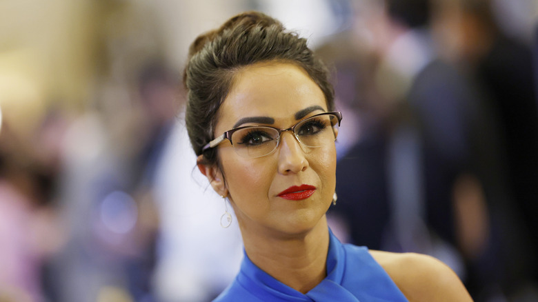 Close up of Lauren Boebert with a red lip and a blue dress.