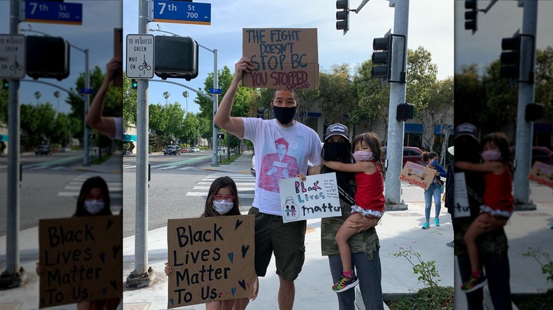 Paul Song and his family holding up Black Lives Matter signs