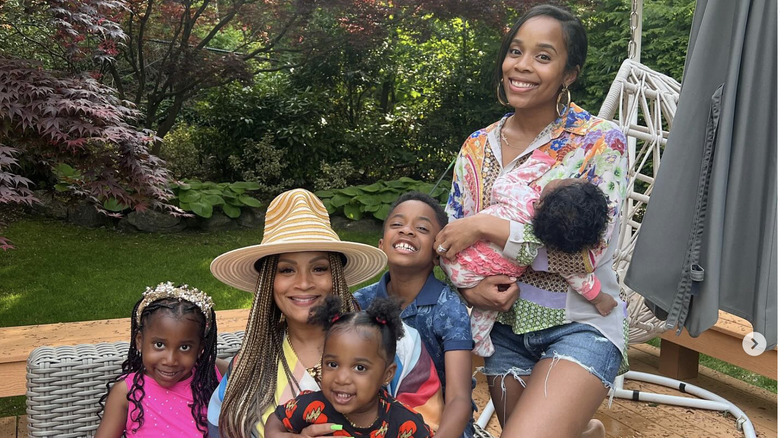 Simone I. Smith sitting outside with her grandchildren and daughter