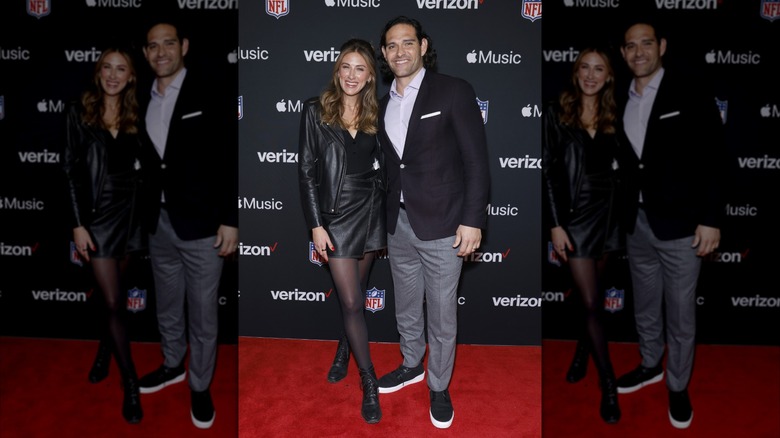 Mark Sanchez and Perry Mattfeld posing on a red carpet