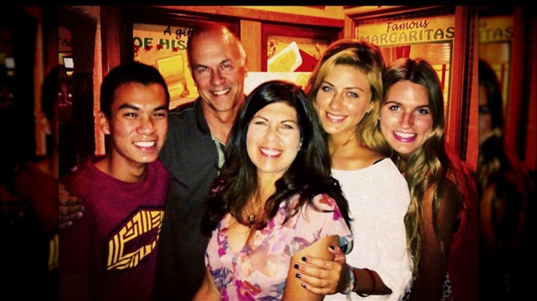 Perry Mattfeld posing with her family at a bar