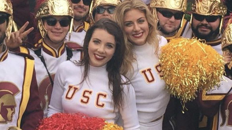 Perry Mattfeld in her cheer uniform with the USC marching band