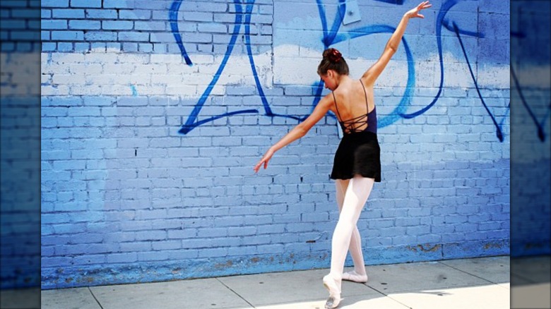 A young Perry Mattfeld posing in a leotard and tights