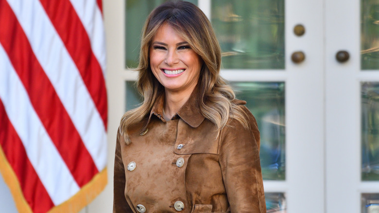 Melania Trump next to American flag