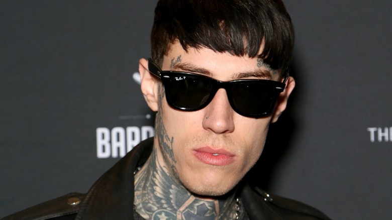 A closeup of Trace Cyrus in black sunglasses