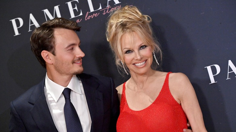 Brandon Thomas Lee smiling at Pamela Anderson on a step-and-repeat for Pamela, a love story