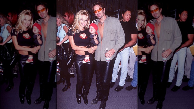 Tommy Lee and Pamela Anderson, who is holding their infant son Brandon in a red hat