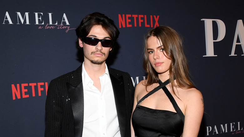Dylan Jagger Lee and Paula Bruss smiling at the premiere of Netflix's "Pamela, A Love Story" in 2023
