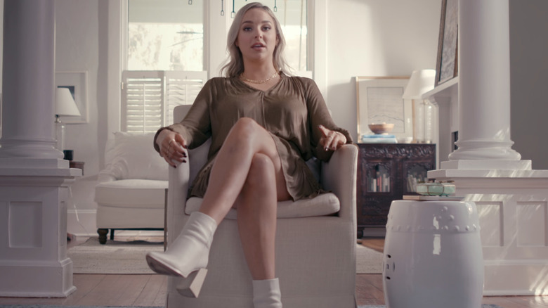 Paul Murdaugh's ex-girlfriend, Morgan Doughty Bostick, sits wearing a brown dress in a chair looking at the camera in a Netflix interview