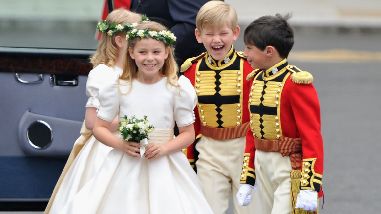 A young  Lady Margarita Armstrong-Jones smiles in a white bridesmaid dress at Prince William and Princess Catherine's wedding