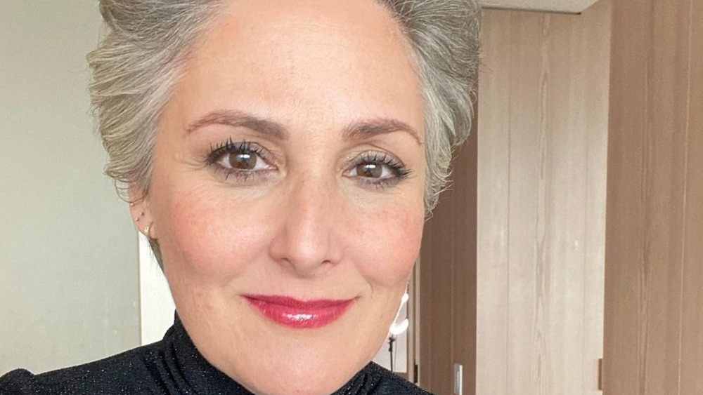 Ricki Lake grinning with short grey hair