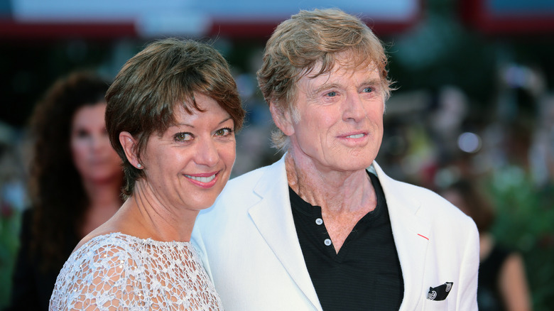 Robert Redford and Sibylle Szaggars smiling at an event
