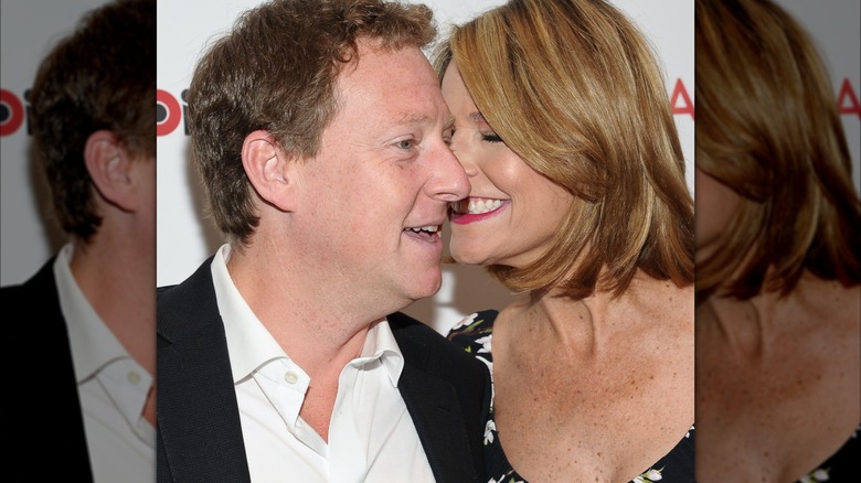 Savannah Guthrie planting a kiss on Michael Feldman's cheek