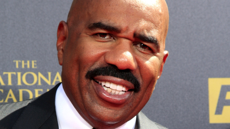 Steve Harvey smiles on the red carpet