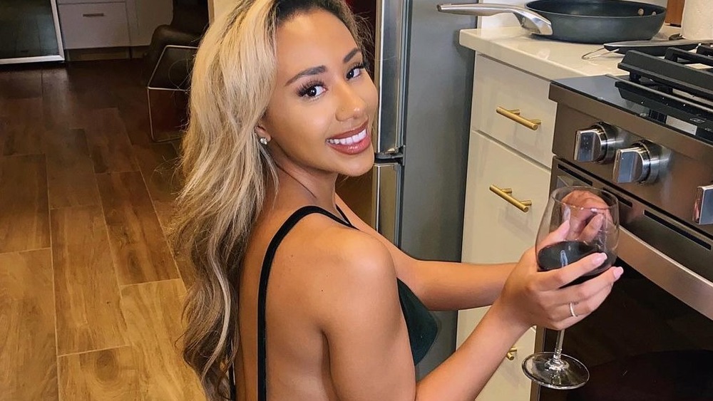 Emani Curl holding wine glass
