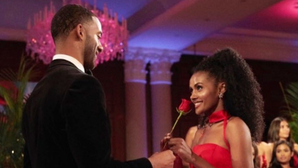The Bachelor's Magi Tareke accepts a rose from Matt James