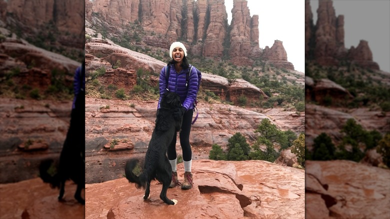 Shreya Chilukuri hiking with a dog