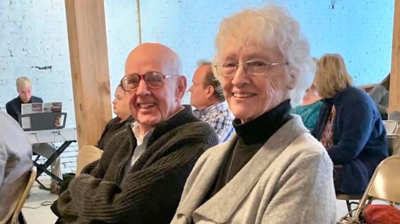 Wendell and Tanya Berry smiling while sitting among other people