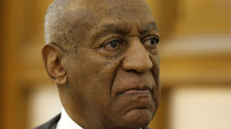 Bill Cosby wearing a dark suit