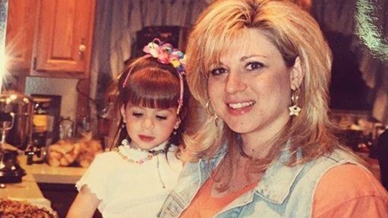 A young Victoria Caputo being held by Theresa Caputo in the late '90s