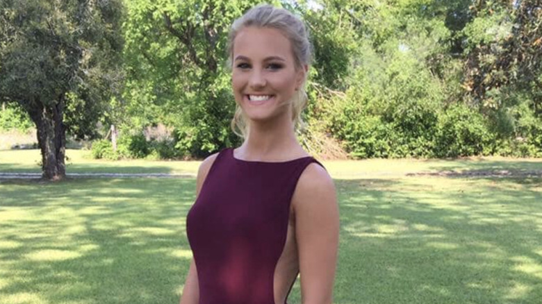 Mallory Beach smiling on lawn in formal dress