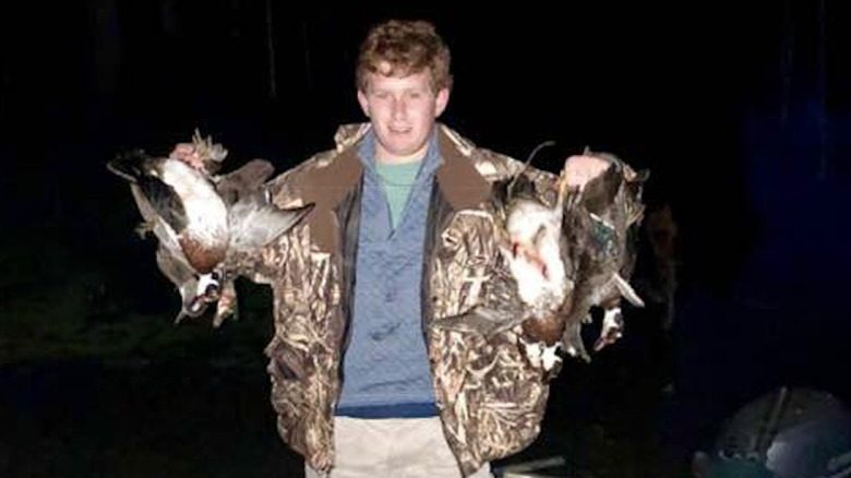 Paul Murdaugh holding up dead birds after a hunt