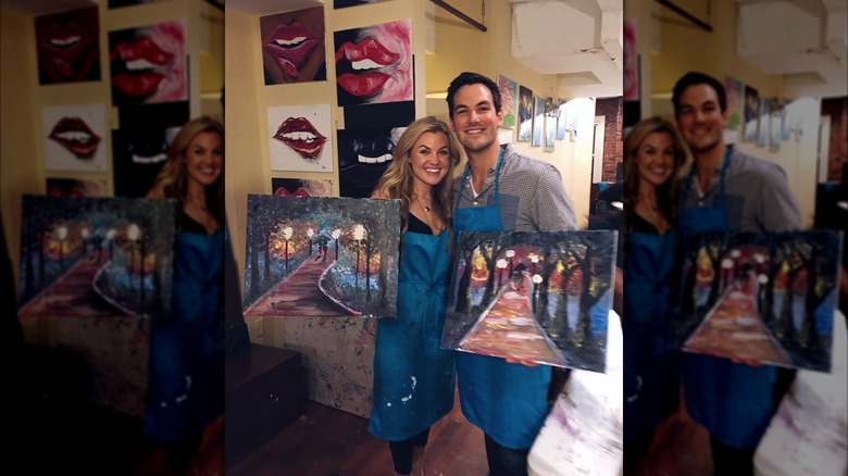 Erika Kirk holding a painting with Cabot Phillips