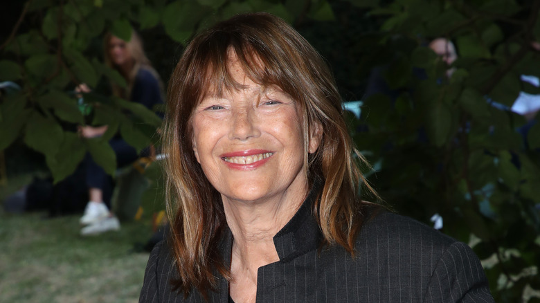 Jane Birkin wearing black smiling