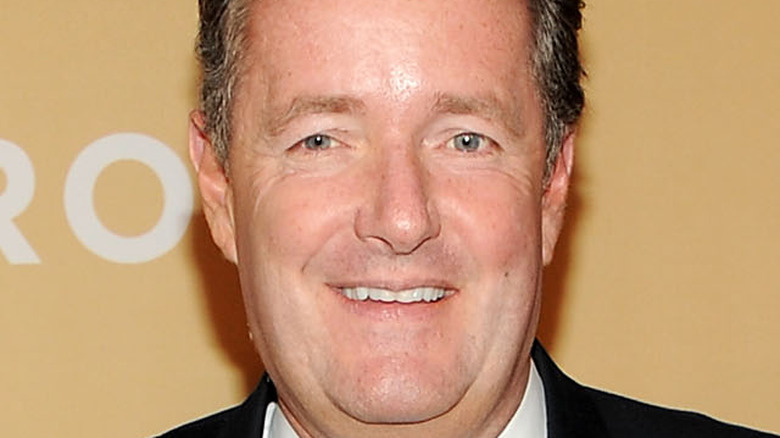 Piers Morgan smiles on the red carpet