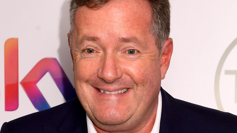 Piers Morgan smiles on the red carpet